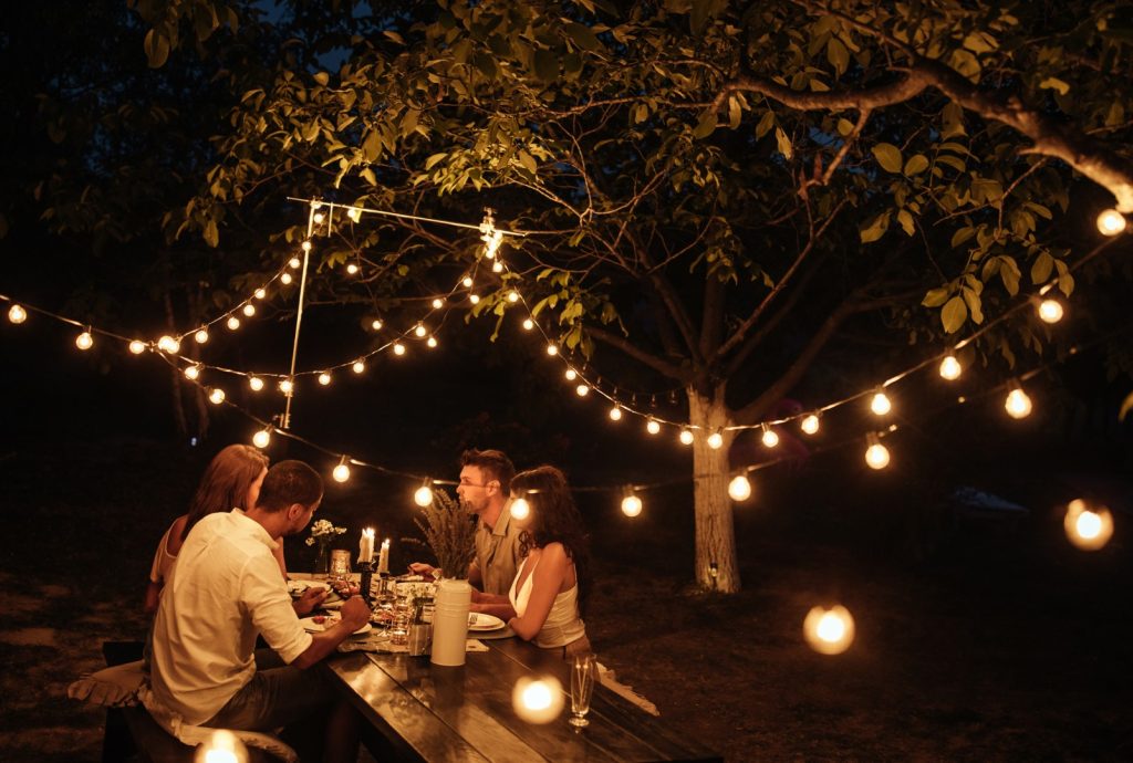 Luxury outdoor private dining experience with string lights and catered dinner in the Okanagan
